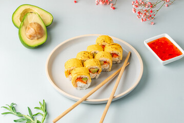 japanese sushi rolls in cheddar cheese on a colored background