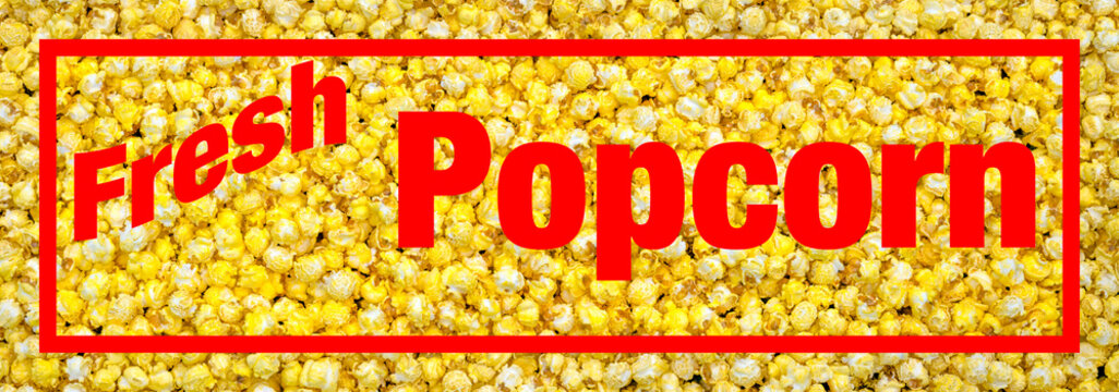 Close upon Fresh popped Movie Theater style buttery popcorn sign or banner