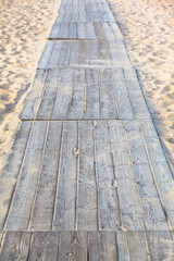 Way of Planks to the Sea / Wooden walkway on sandy beach (copy space) - 503819702