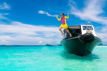 Child jumping into sea water. Yacht vacation.