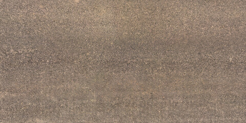 view from above on surface texture of old asphalt road with cracks