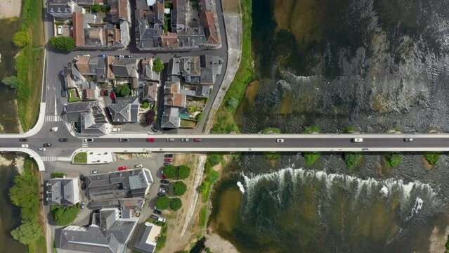 Aerial top view on Pont du Marechal Leclerc over Loire river with cars from drone. Sunny day, traffic, waves, gren landscape on the island. Amboise bridge. HD
