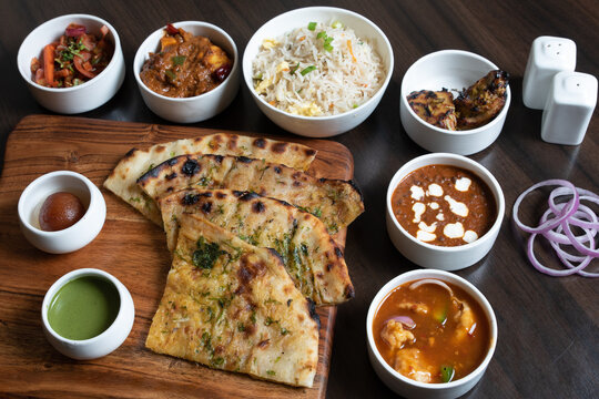 Shot of the roti sliced and types of side dishes kept on the table for taste with sauces and onions