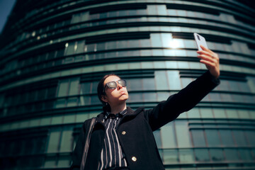 Funny Businesswoman Taking a selfie in front of an Office Building