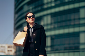 Happy Woman in Big City Holding a Shopping Bag