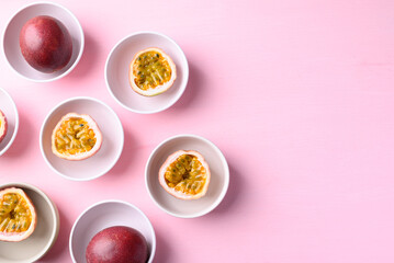 Passion fruit in bowl on pink, Tropical fruit in summer season