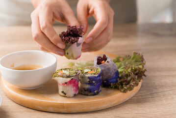 Fototapeta na wymiar Fresh spring roll with flower and vegetable, Vegan food cooking