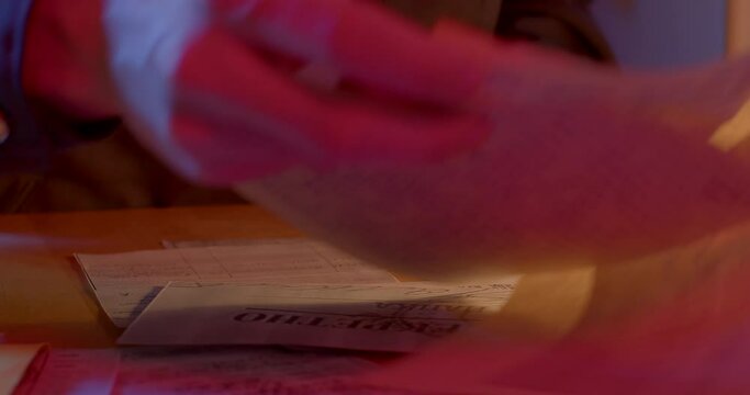 A close-up of the hands of an employee of the secret police examines the document, takes paper out of the envelope, examines it. Folds and puts in the inside pocket. Collection of human data.