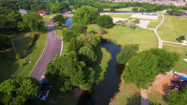 Aerial footage of Bear Creek Park in Keller Texas. Camera is heading west is is on the western end of the park.