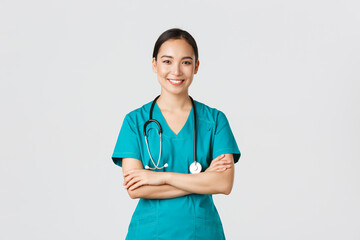 Covid-19, healthcare workers, pandemic concept. Portrait of confident smiling, attractive asian...