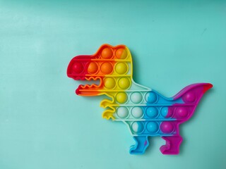 Colorful anti-stress fidget push pop it in the shape of a dinosaur