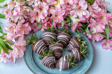 Chocolate covered strawberries  and pink flowers alstroemeria