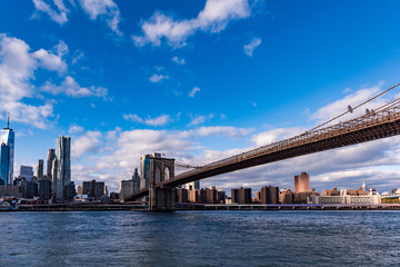 Brooklyn Bridge and lower east side are seen from Downtown Brooklyn under a blue sky