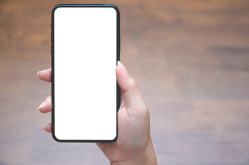 Close up women using a smartphone with an empty white screen at the wooden interior cafe.