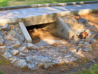 drainage culvert bridge city park sidewalk water ditch public stream community concrete path...