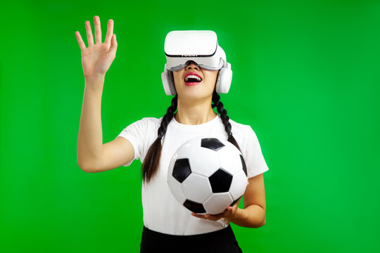 Asian woman in vr glasses, virtual reality headset, holding a soccer ball and touching something, football sport and Metaverse Concepts