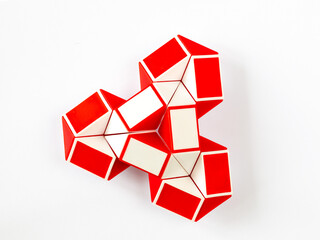 red and white bicolor magic snake Transformable twist puzzle in shape of flower, bow or spinner...