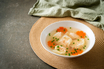 shrimp dumpling soup in white bowl