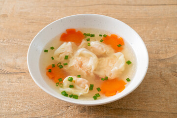 shrimp dumpling soup in white bowl