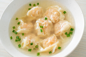shrimp dumpling soup in white bowl