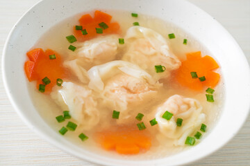 shrimp dumpling soup in white bowl
