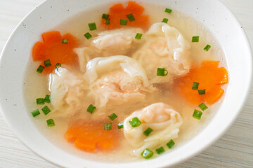 shrimp dumpling soup in white bowl