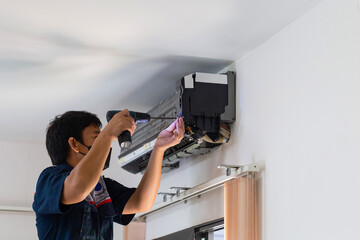 Air Conditioning Repair, Repairman fixing air conditioning system, Male technician service for repair and maintenance of air conditioners
