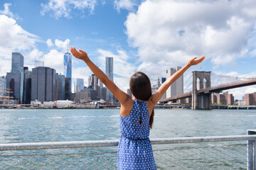 Success in business career in New York. Aspirational Happy free woman cheering by NYC New York city urban skyline with arms up raised in the sky. Goal achievement carefree freedom successful person