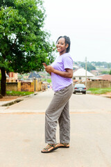 portrait image of a young black girl posing for the camera with nice sandals