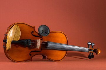 Still life with a violin and a small acoustic speaker
