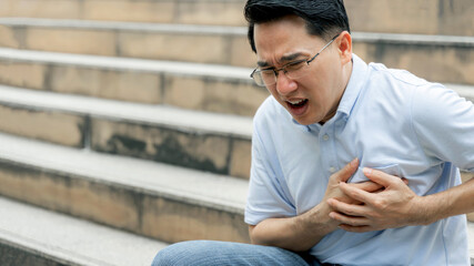 Obraz premium asian male suffering from bad pain in his chest heart attack- senior heart disease