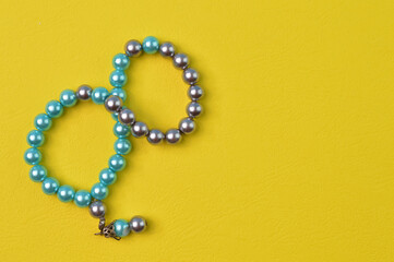 Pearls bracelet isolated on a yellow background