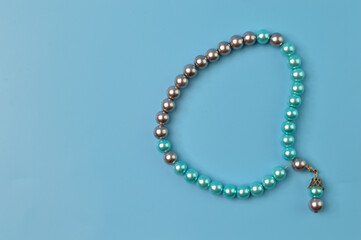 Pearls bracelet isolated on a blue background