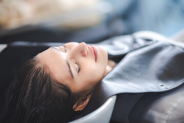 hairdresser washing client's hair at salon. happy young women customer relax and comfortable while washing hair, luxury hair spa by professional hairstylist