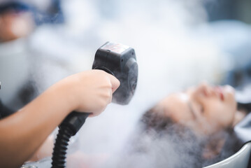 hairdresser washing client's hair at salon. happy young women customer relax and comfortable while...