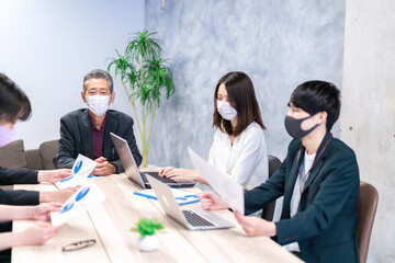 Business people working with masks on