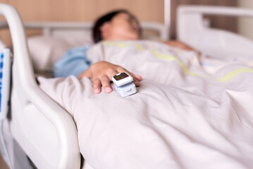 Obraz premium Pulse oximeter on hands patient at hospital,Oxygen saturation meter blood monitor finger