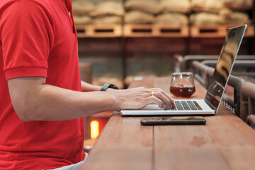 Casual Businessman using smartphone and laptop, freelance man typing keyboard computer notebook in cafe or modern office. technology, digital online and network concept