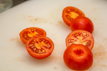 tomato halves isolated. Fresh small cherry tomatoes, mini organic cocktail tomate slice on white background