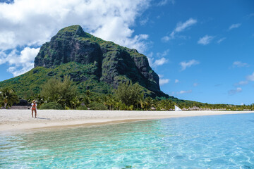 Le Morne beach Mauritius Tropical beach with palm trees and white sand blue ocean and beach beds...