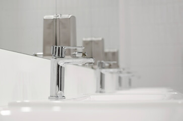 Bathroom interior with sink and faucet. Close-up, selective focus.