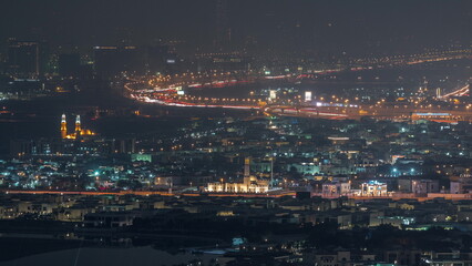 Aerial view of many apartment houses in Dubai city from above night timelapse
