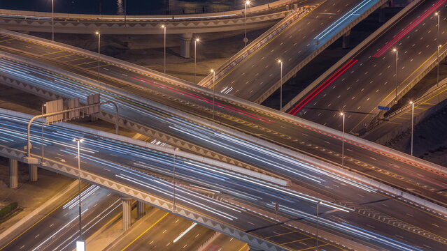 Top view city traffic on a big crossroad in Business bay night timelapse. © neiezhmakov