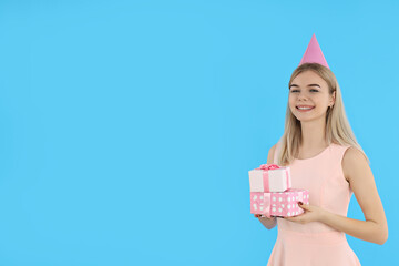 Concept of Happy Birthday, young woman on blue background