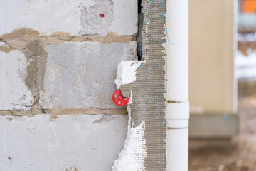 Obraz na płótnie Canvas Polystyrene foam glued to an aerated concrete block wall
