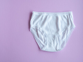 Underwear for children. White panties for girls on purple, knitted cotton underwear. Underwear for children