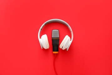 Headphones and microphone on red background