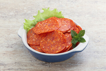 Sliced pepperoni sausage in the bowl