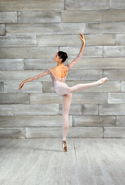 Active ballerina performing attitude pose