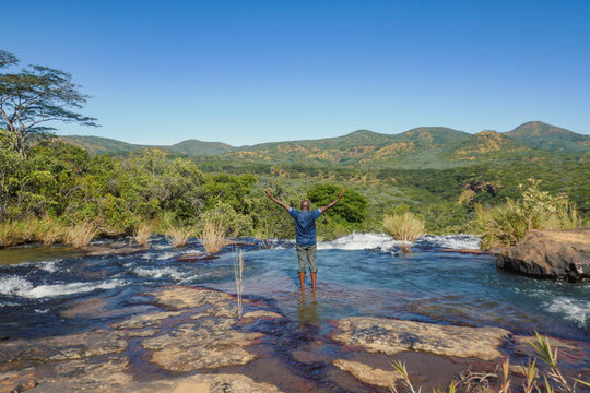 Rear view of a man having fun at Kimani River in Mpanga Kipengele Game Reserve, Tanzania